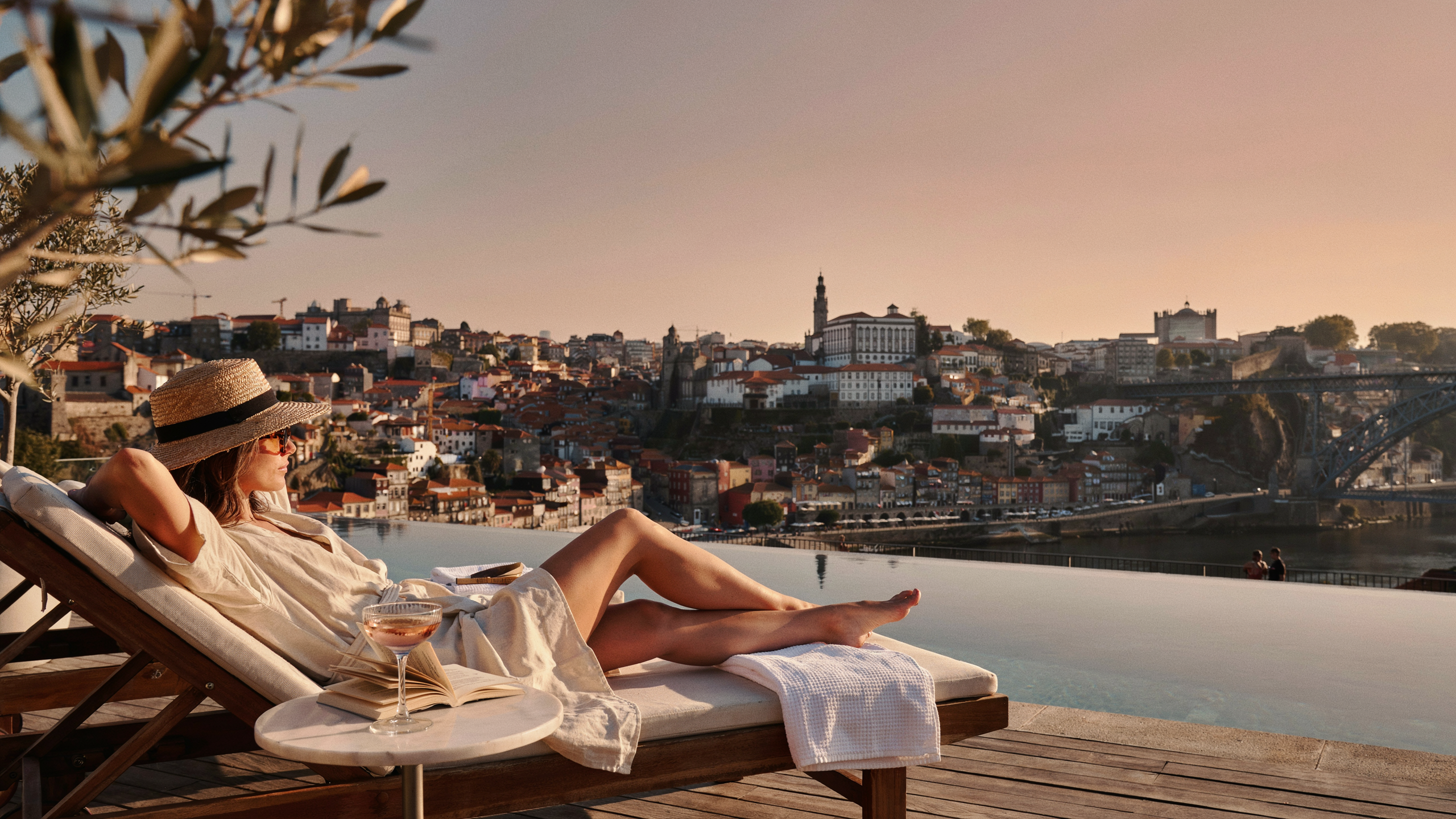 Luxury hotel infinity pool overlooking Porto and the Douro River at sunset